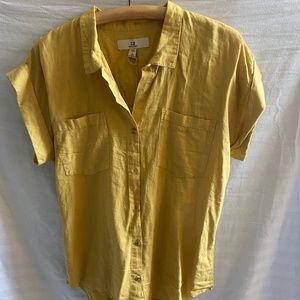Yellow, collared button down shirt.